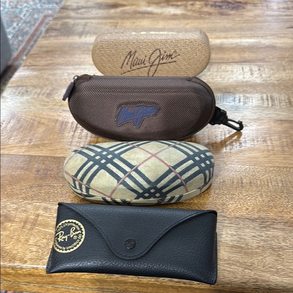 Gucci, Ray-Ban and Maui Jim Sunglasses cases.